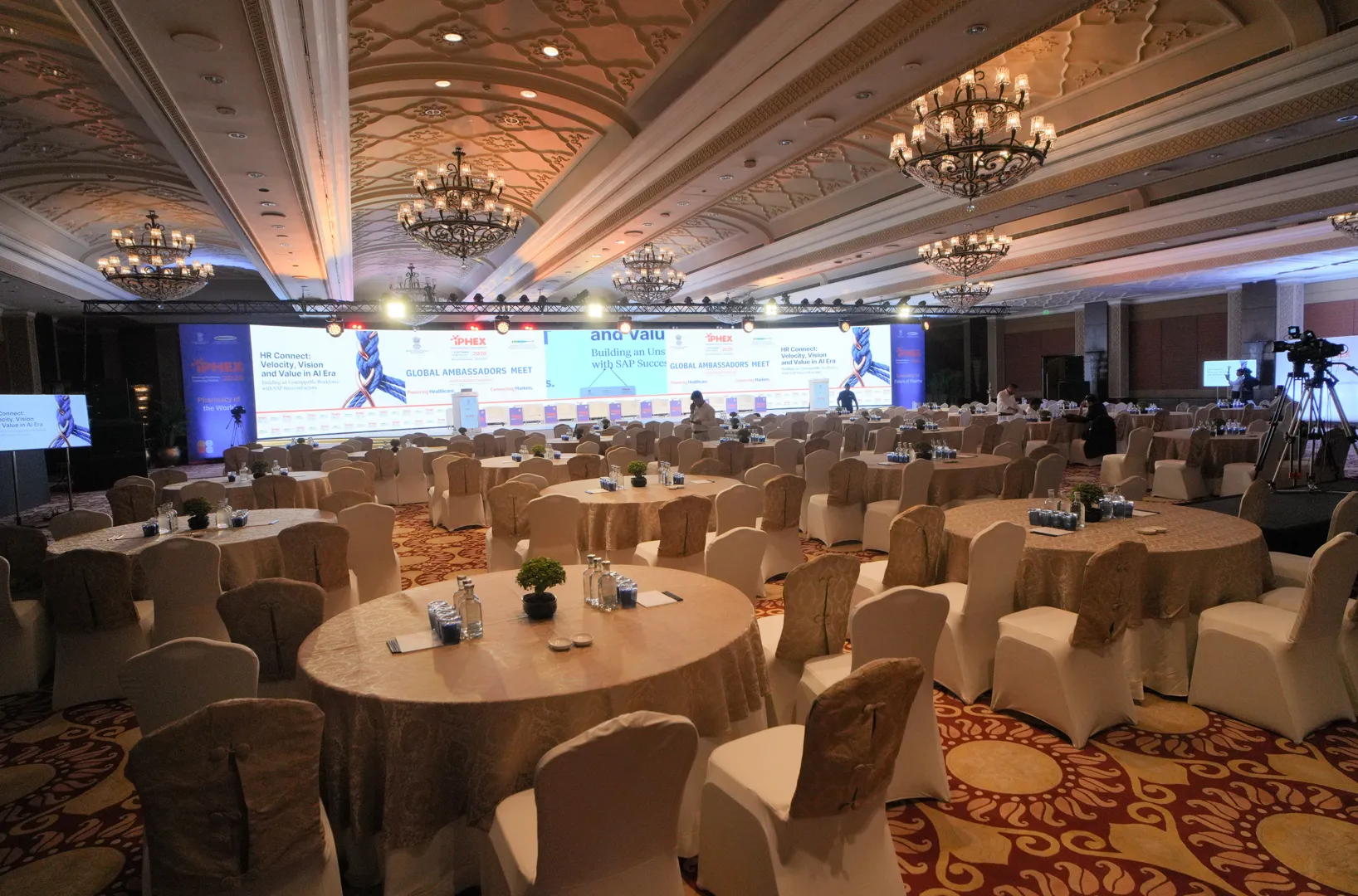 Event hall set up with round tables before delegates arrive